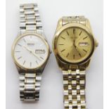 Two gents Seiko quartz wristwatches, one gold plated, one stainless steel. Both require batteries.