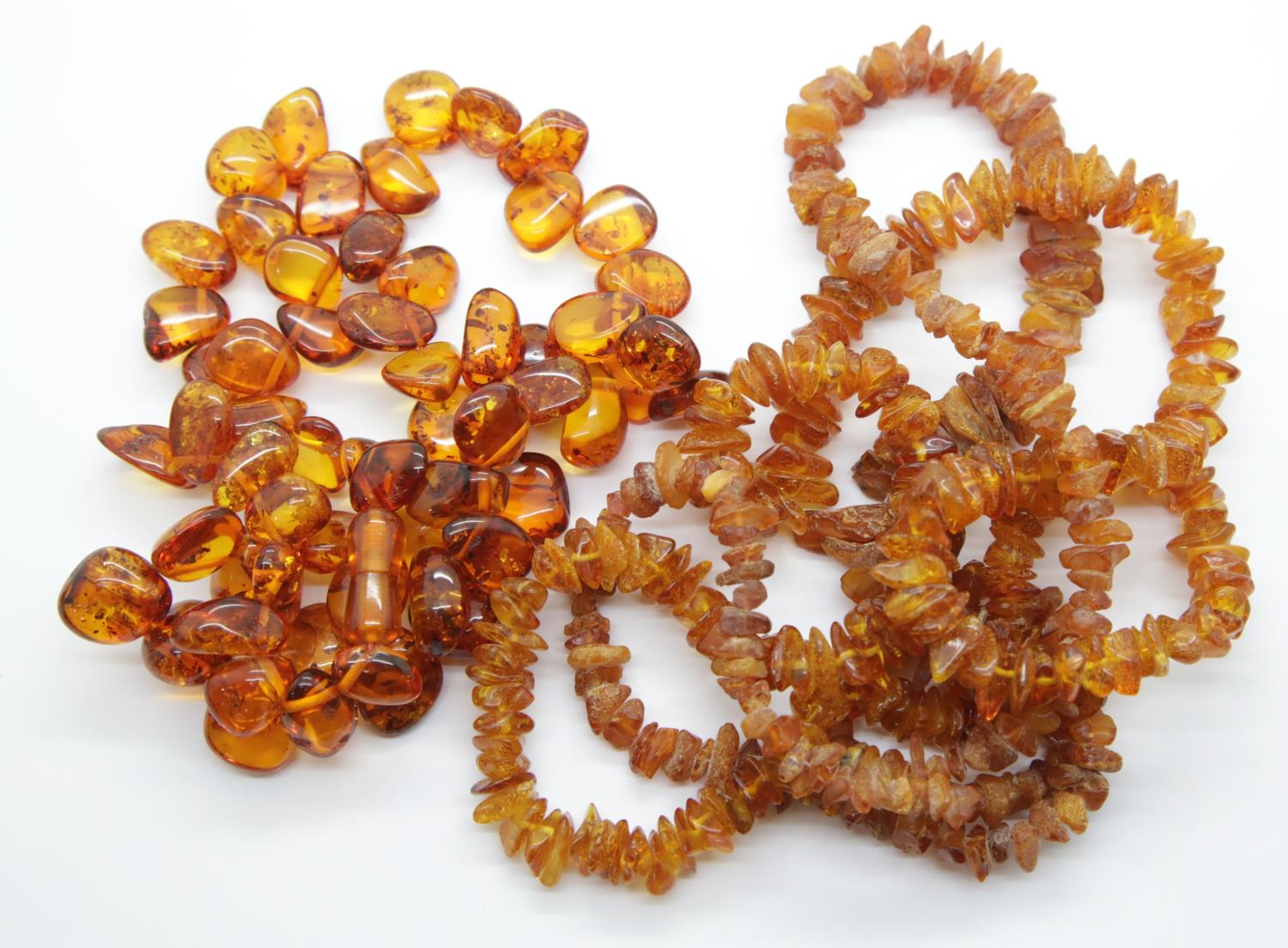 Two rough amber necklaces and a polished example. P&P Group 1 (£14+VAT for the first lot and £1+