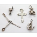 Four silver charms and a hallmarked silver cross pendant. P&P Group 1 (£14+VAT for the first lot and