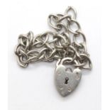 Silver solid link bracelet for charms, with a heart padlock clasp. P&P Group 1 (£14+VAT for the