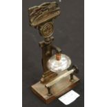A bronzed desk gong with cast relief of Llandudno Pier and Great Orme, with striker and bell, H: