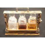Betjemann, London rosewood based three-bottle tantalus with silver plated fittings, lock and handle,
