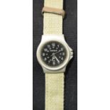 Military type black faced wristwatch on a canvas strap. P&P Group 1 (£14+VAT for the first lot