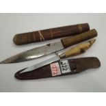 Goat foot handled knife and scabbard, and an African wood handled knife and scabbard. P&P Group