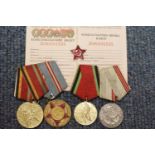 Group of four Russian medals with documentation. P&P Group 1 (£14+VAT for the first lot and £1+VAT