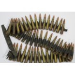 Machine gun cartridge belt containing approximately 50 tipped inert bullets. P&P Group 1 (£14+VAT