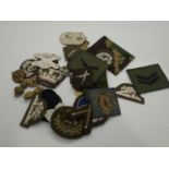 Metal tin containing fabric and metal military badges. P&P Group 1 (£14+VAT for the first lot and £