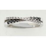 18ct white gold sapphire and diamond crossover ring, size P, 4.4g. P&P Group 1 (£14+VAT for the