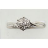 18ct white gold six-claw set diamond flower head cluster ring, size M, 2.7g. P&P Group 1 (£14+VAT