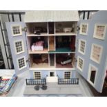 Large Georgian style dolls house with internal lighting. Opening frontage with some furniture and