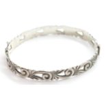 Silver 1970s scroll design hinged bangle. P&P Group 1 (£14+VAT for the first lot and £1+VAT for