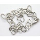 Silver vintage 1970s oval link bracelet with five heart charms. P&P Group 1 (£14+VAT for the first