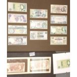 Two framed Fforde 10 Shilling notes and eleven £1 notes, please note the £1 notes have old sellotape