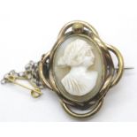 Victorian pinchbeck cameo brooch with safety chain,L: 3 cm. P&P Group 1 (£14+ VAT for the first