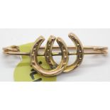 Antique 9ct rose gold double horseshoe brooch. P&P Group 1 (£14+VAT for the first lot and £1+VAT for