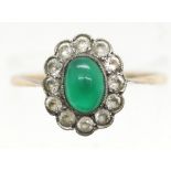 Yellow gold (marks rubbed) ring set with green cabochon surrounded by white stones, size P, 2.3g.