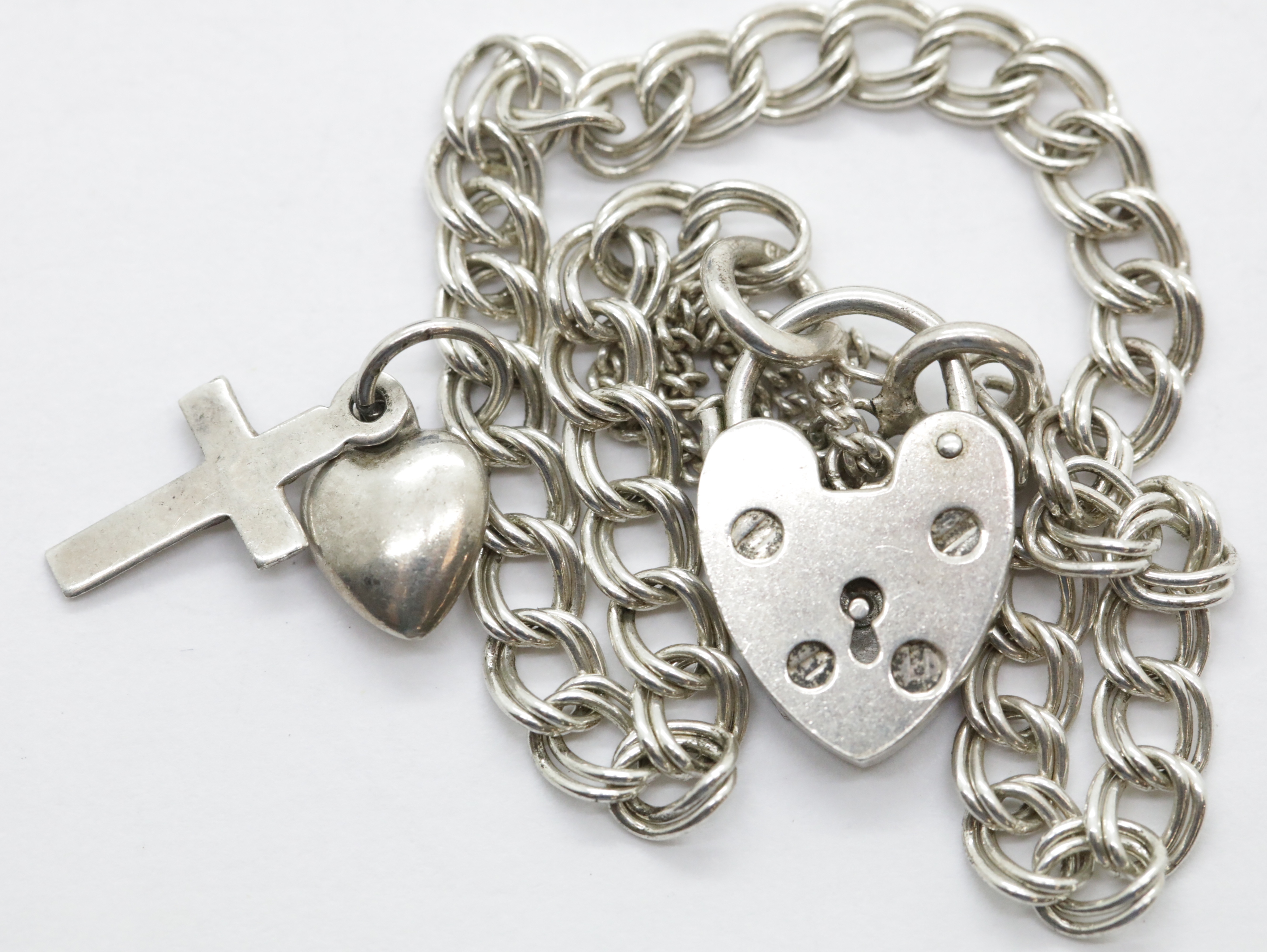 Silver 1970s double link charm bracelet with safety chain and padlock. P&P Group 1 (£14+VAT for