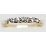Unmarked yellow gold seven diamond ring, size M, 2.5g. P&P Group 1 (£14+VAT for the first lot and £