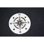 Circular cast iron compass points sign, D: 9 cm. P&P Group 1 (£14+VAT for the first lot and £1+VAT