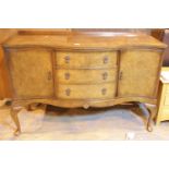 Burr walnut bow fronted sideboard with three drawers and two side cupboards. This lot is not