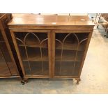 Double door glass fronted display cabinet with two wooden shelves, 110 x 93 cm. This lot is not