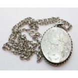 Hallmarked silver locket with presumed silver chain, assay Birmingham 1974, L: 4 cm. P&P Group 1 (£