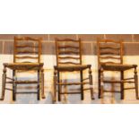 Three ladderback chairs with rush seats. This lot is not available for in-house P&P, please