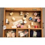 Wooden box containing sewing items including cotton reels. P&P Group 2 (£18+VAT for the first lot