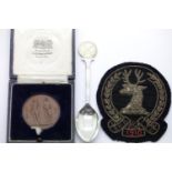 Hallmarked silver shooting teaspoon boxed bronze shooting metal and a fabric badge. P&P Group 1 (£