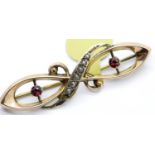 Antique 9ct rose gold, ruby and seed pearl brooch, L: 40 mm, 1.7g. P&P Group 1 (£14+VAT for the