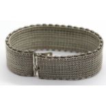 Unmarked presumed silver mesh bracelet with safety chain. P&P Group 1 (£14+VAT for the first lot and