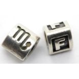 Two genuine Pandora charms stamped A.L.E, largest L: 9mm. P&P Group 1 (£14+VAT for the first lot and