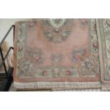 Pink ground floral rug with fringe, L: 2.8m, W: 1.8m. This lot is not available for in-house P&P,
