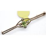 Antique 9ct rose gold peridot and seed pearl brooch, L: 45 mm, 2.0g. P&P Group 1 (£14+VAT for the