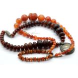 Two amber coloured bead necklaces and a similar bracelet. P&P Group 1 (£14+VAT for the first lot and