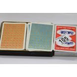 Boxed set of Playboy type playing cards and a vintage set of playing cards with advertising backs.