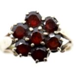 Ladies 9ct gold and seven stone garnet daisy cluster ring, size K, 3.3g. P&P Group 1 (£14+VAT for