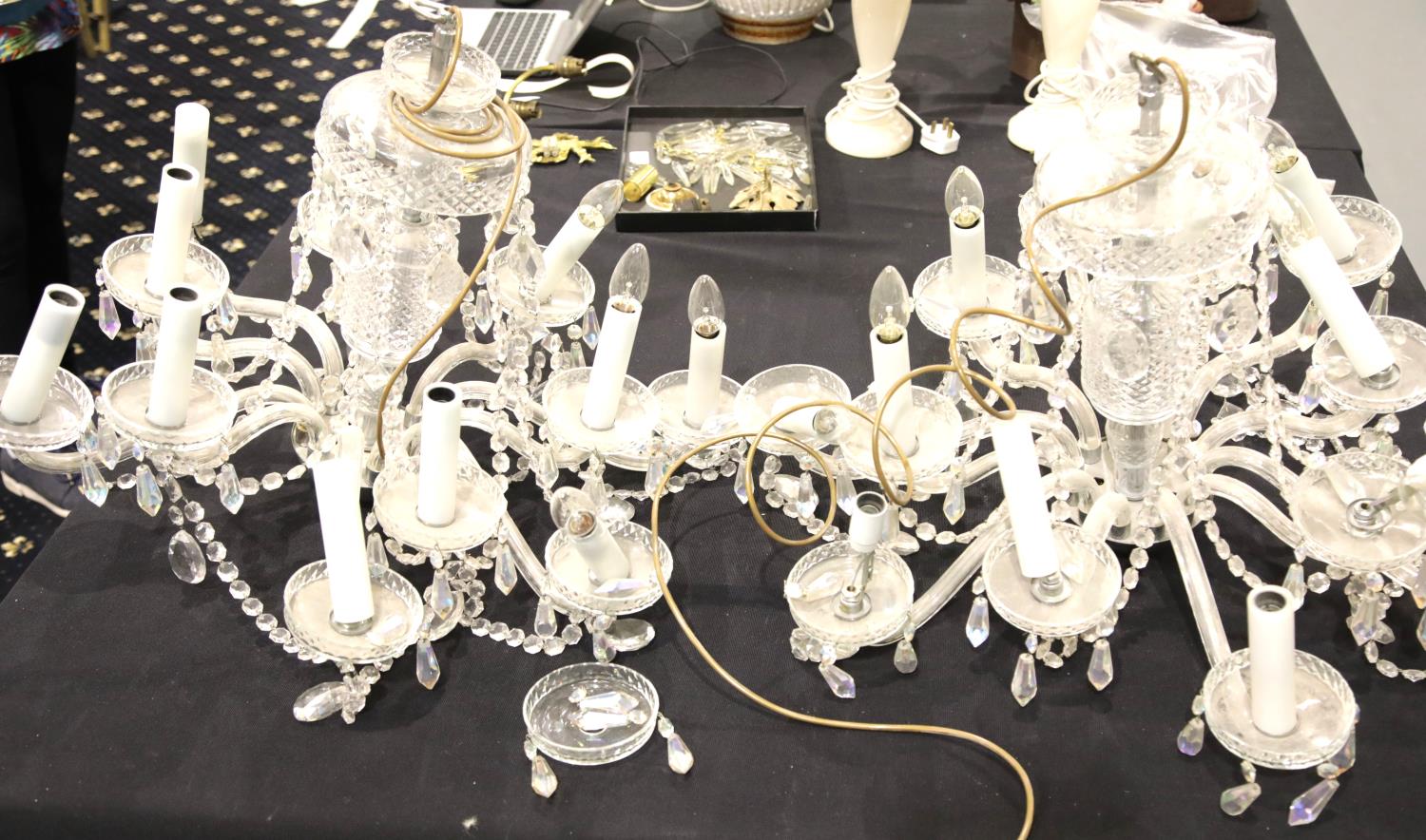 Pair of mid 20thC cut glass chandeliers, each having twelve sconces with drops on a glass and