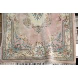 Large pink ground woolen rug with fringe, L: 2.8 m, W: 1.8 m. This lot is not available for in-house
