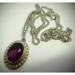 Silver pendant with a faceted purple stone surrounded by seed pearls. P&P Group 1 (£14+VAT for the