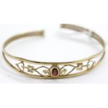 Unmarked presumed 9ct yellow gold garnet set torc bangle W: 65 mm, 4.9g. P&P Group 1 (£14+VAT for