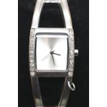 Karen Millen ladies silver plated bangle watch, boxed with papers. Requires battery, signs of loss