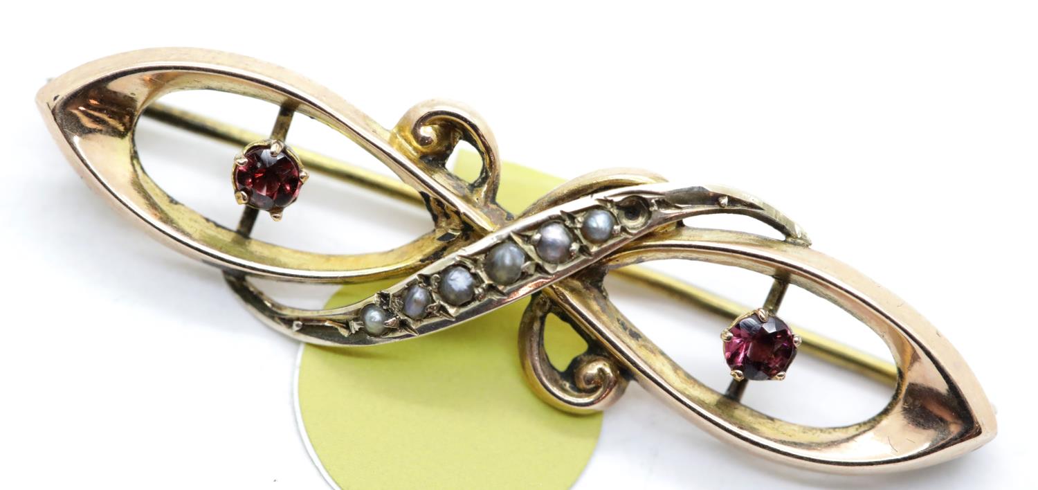 Antique 9ct rose gold, ruby and seed pearl brooch, L: 40 mm, 1.7g. P&P Group 1 (£14+VAT for the