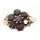 Ladies 9ct gold and seven stone garnet daisy cluster ring, size K, 3.3g. P&P Group 1 (£14+VAT for
