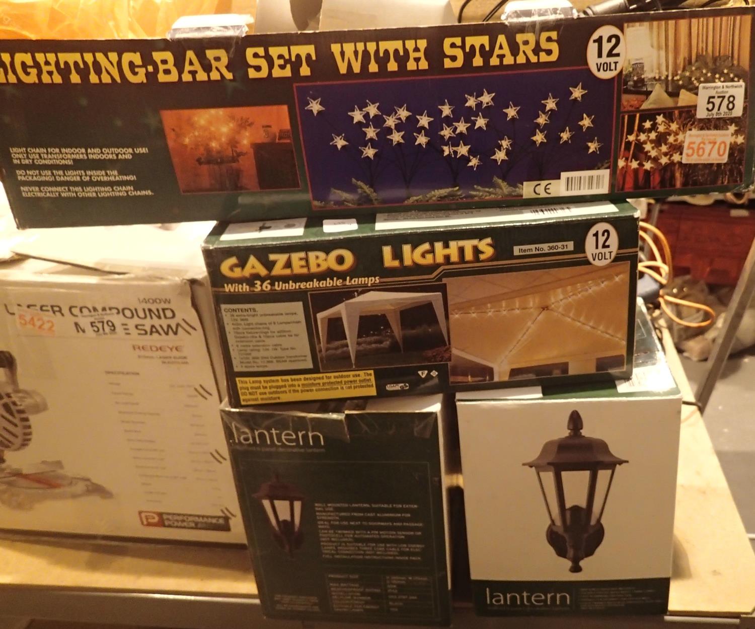 Two exterior lanterns, boxed set of gazebo lights and a lighting bar with stars. This lot is not