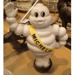 Cast iron Michelin Man waving on tyre moneybox, H: 22 cm. P&P Group 2 (£18+VAT for the first lot and