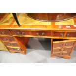 Reproduction yew twin pedestal desk with tooled leather inserts, 148 x 63 x 75 cm. This lot is not