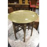 Middle Eastern folding Ciaro table with brass tray top, D: 58 cm. This lot is not available for in-