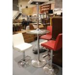 Contemporary stainless steel poseur table with circular glass top, H: 105 cm, D: 70 cm, with two