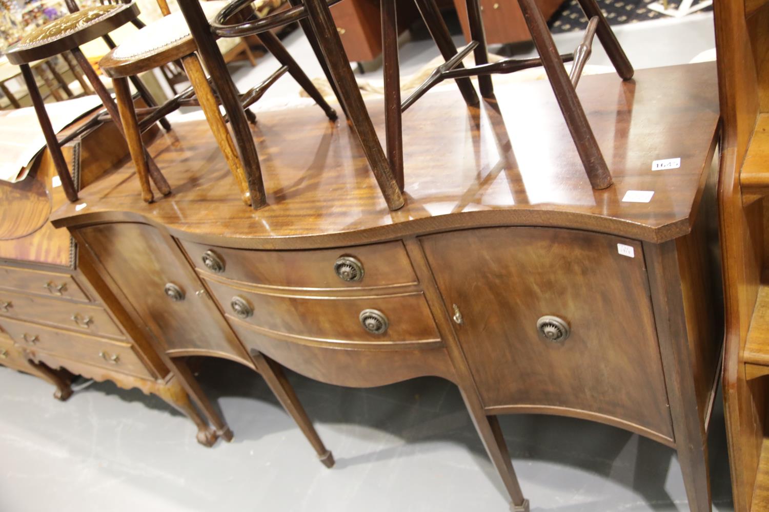 Regency style mahogany serpentine sideboard with three drawers and three cupboards. This lot is